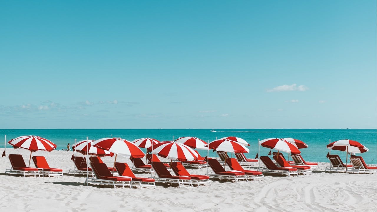 Red and white beach chairs and umbrellas at the beach
