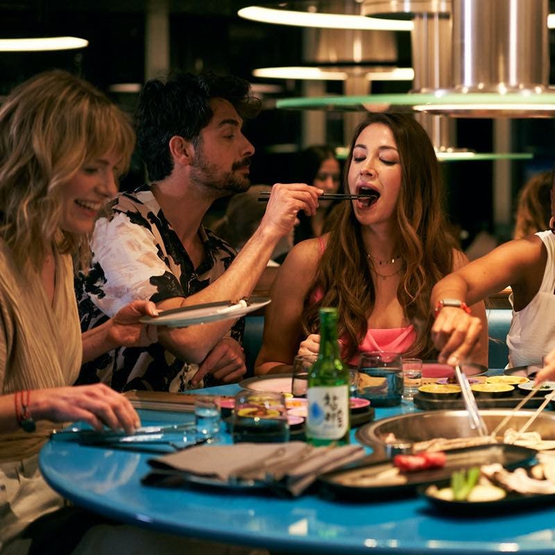A group enjoys Korean BBQ at Gunbae restaurant.