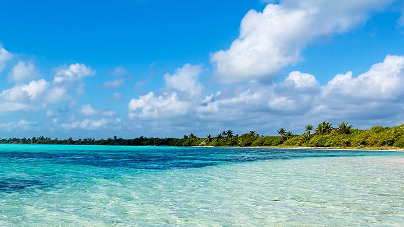 clear blue sea with blue sky and clouds