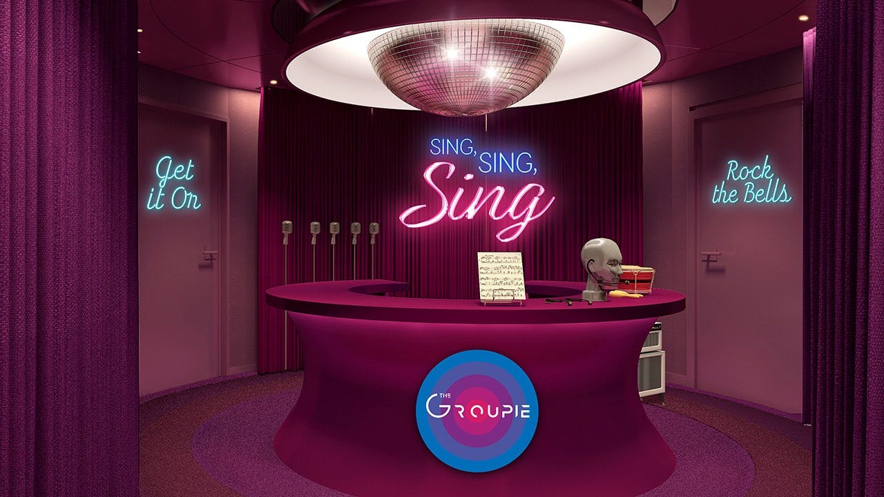 The groupie desk with a disco ball chandelier hanging above