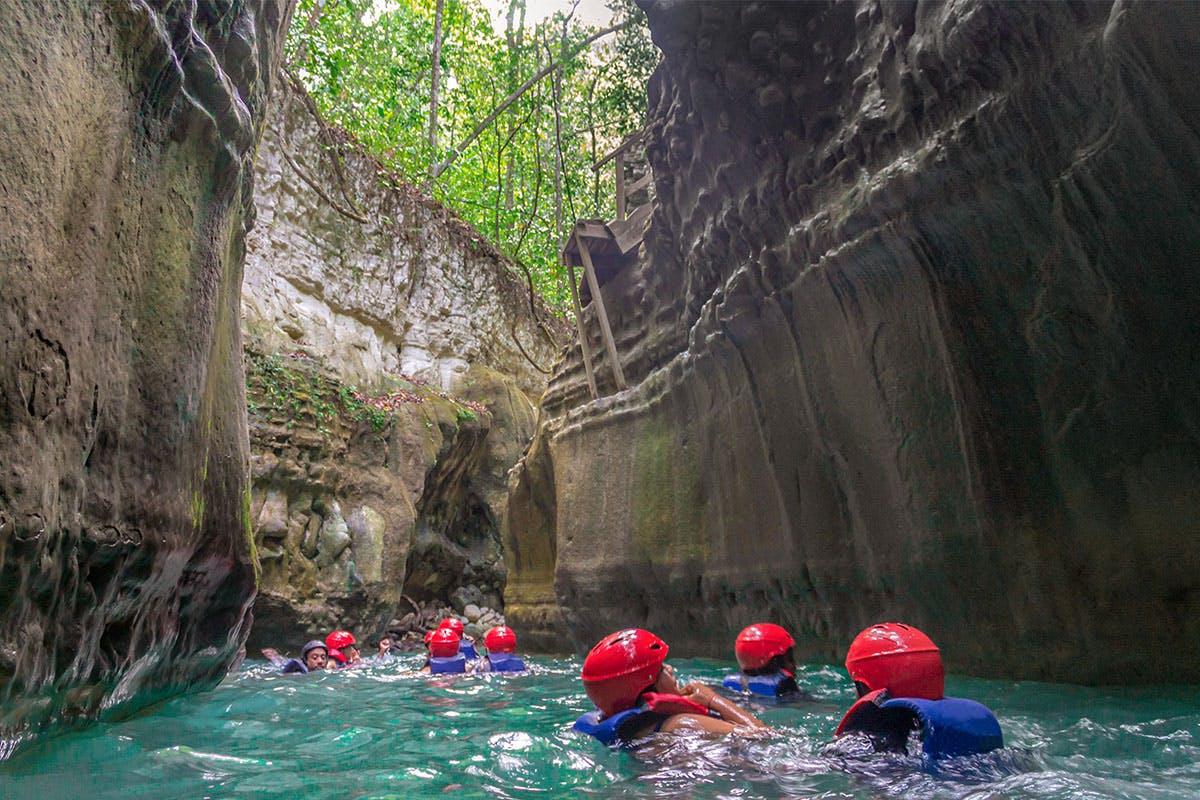 People at the bottom of a waterfall for the Waterfalls of Damajuguas Puerto Plata Shore Thing